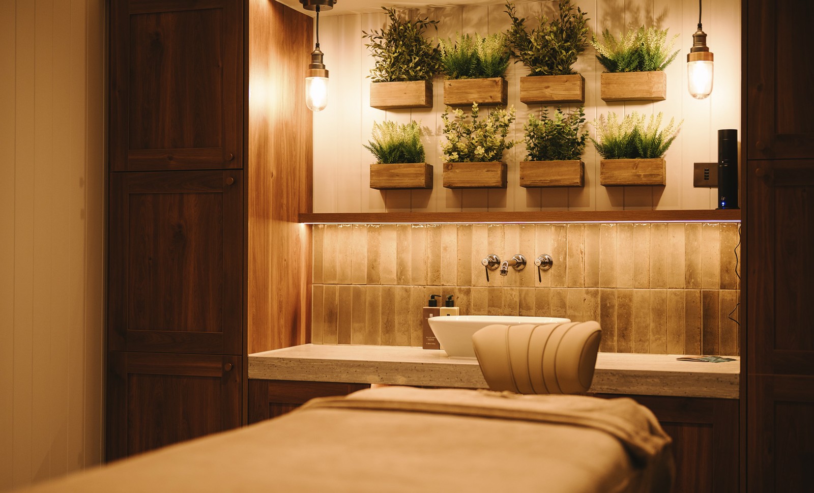 A serene spa treatment room, bathed in soft light, promising relaxation and rejuvenation.