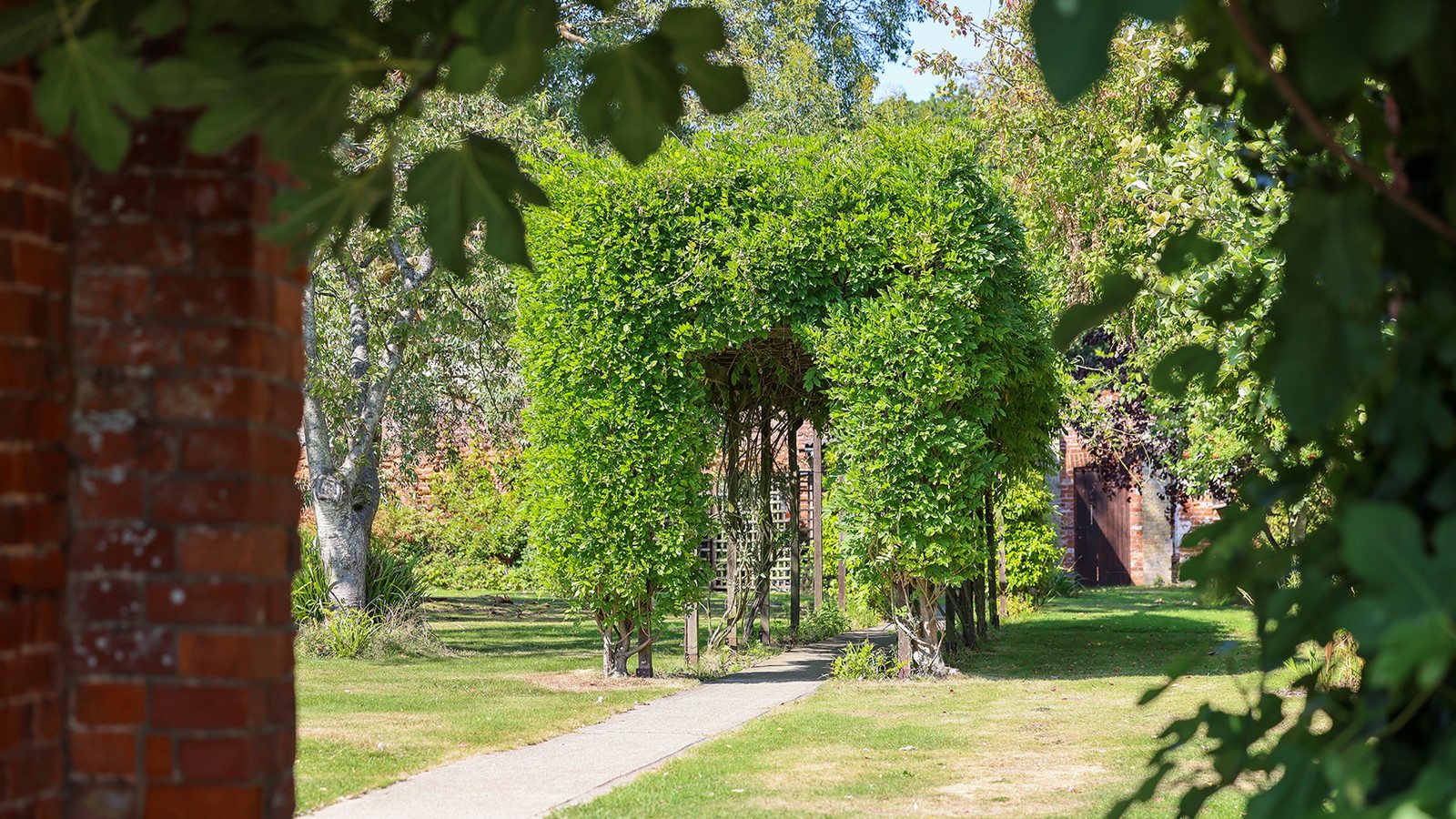 Stroll through the peaceful gardens at Gunton Hall and discover this charming topiary archway along the way.