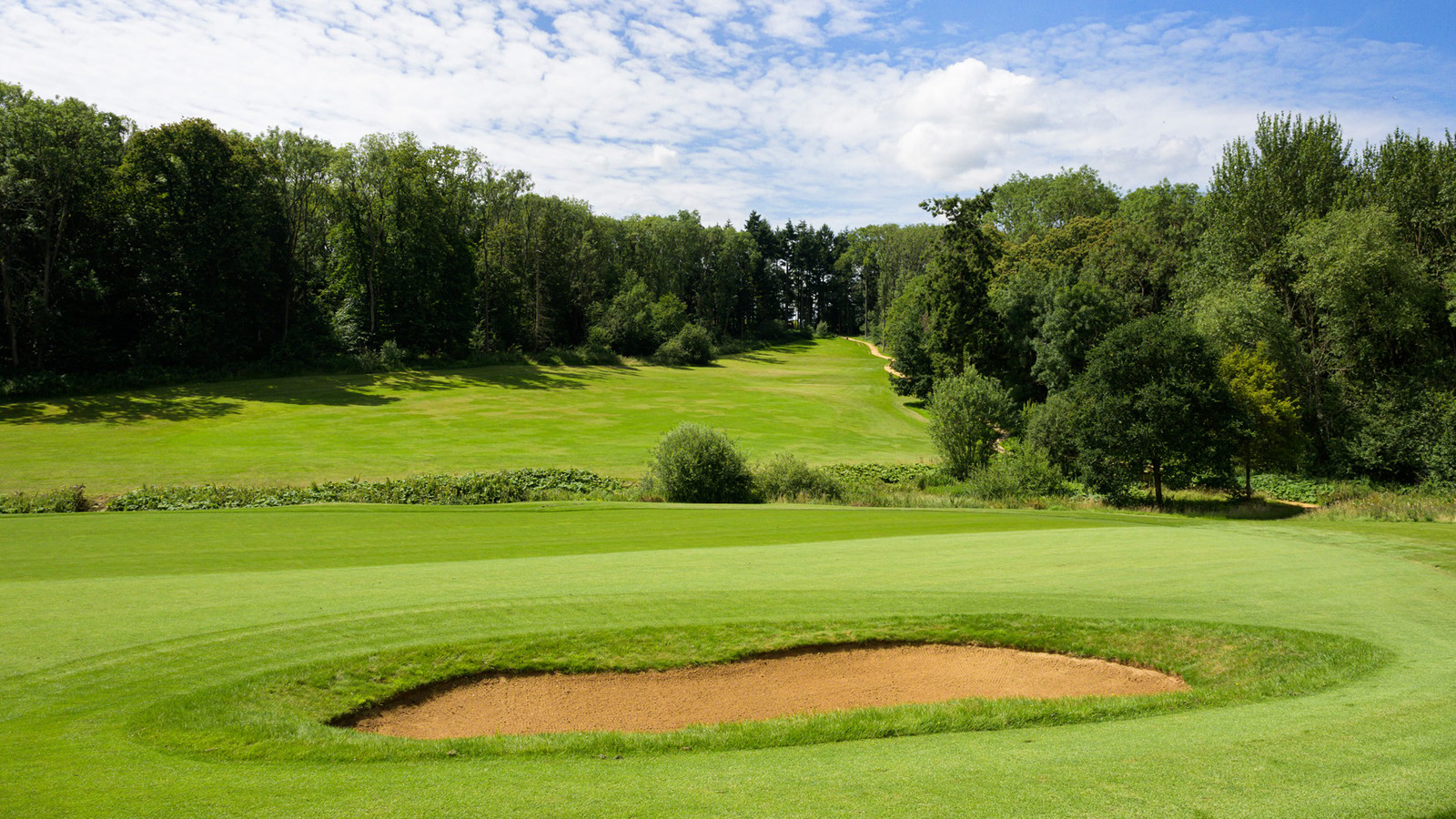 Where every swing comes with a Cotswold backdrop worth pausing for.