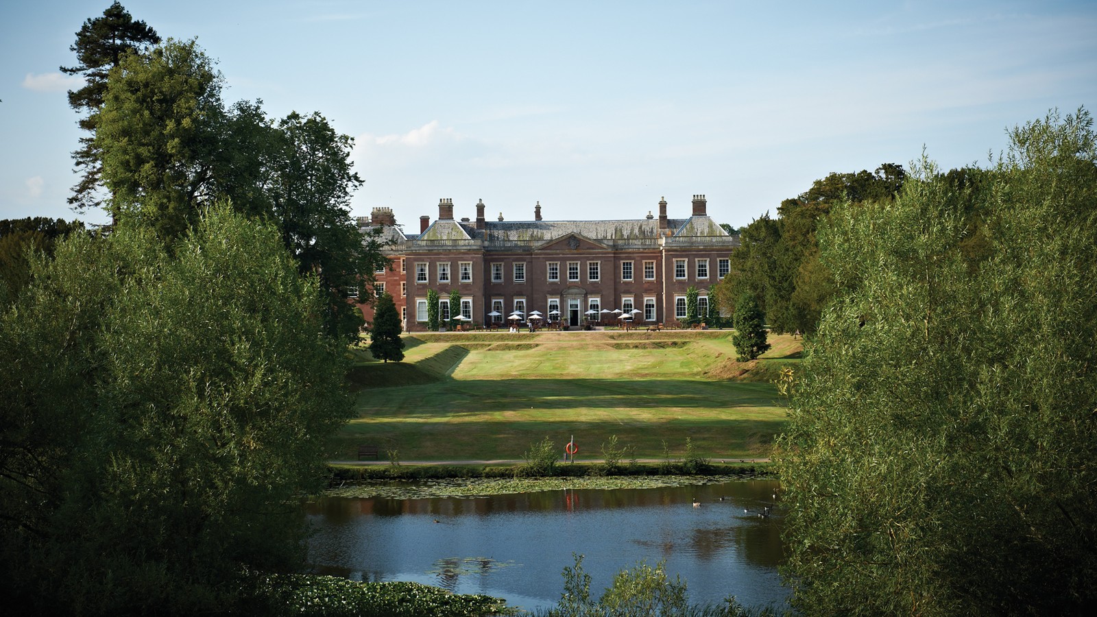 Find this view of the manor house from the opposite side of the vast lake situated in the grounds.