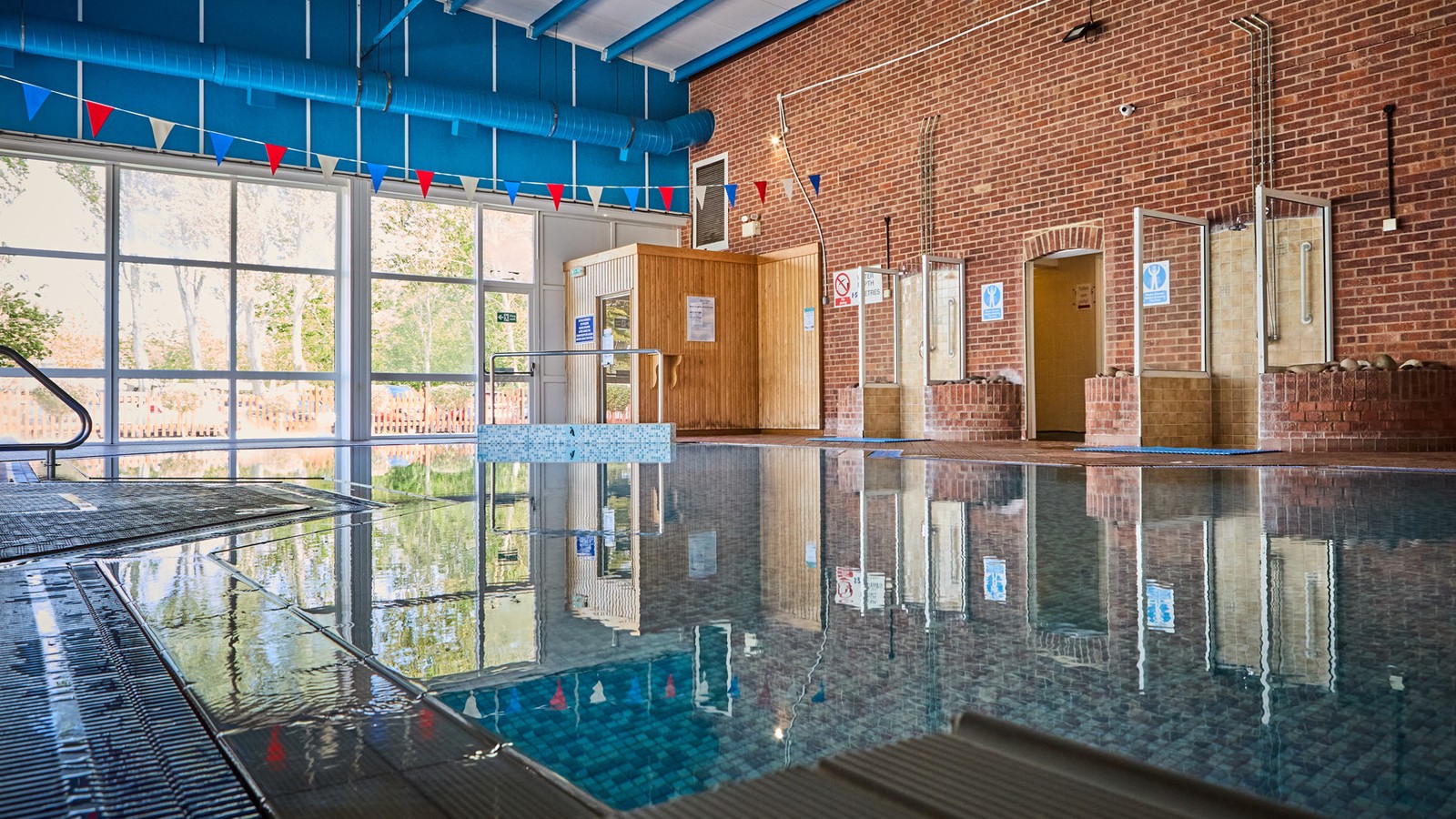 The large indoor pool with big windows offering bright natural light.
