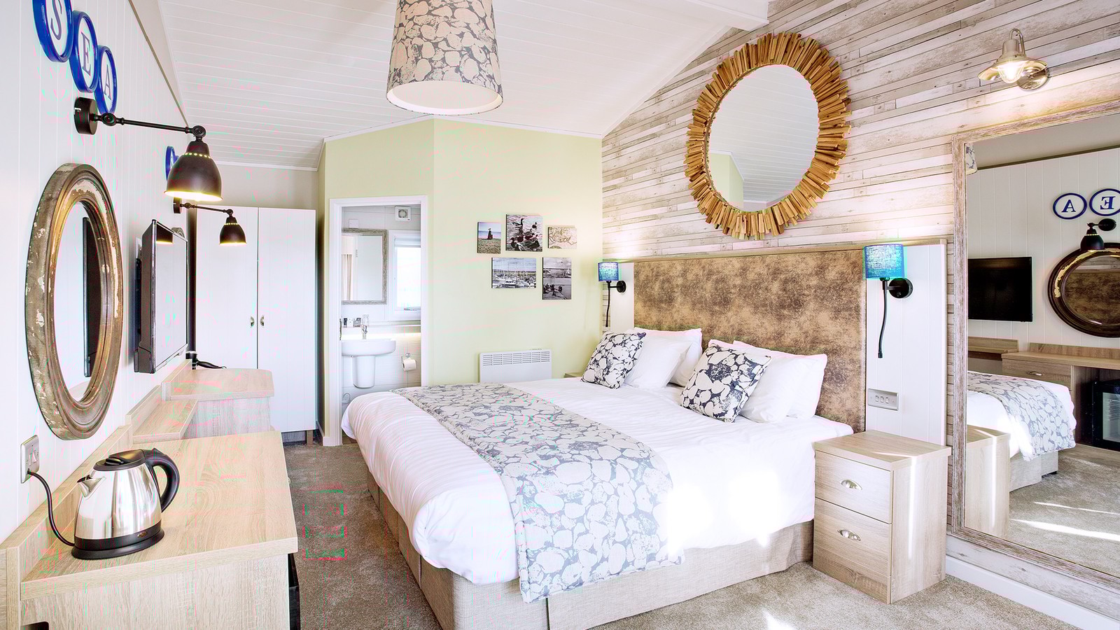 Inside the woodland lodge rooms with a nautical theme featuring a comfortable bed and other modern commodities.