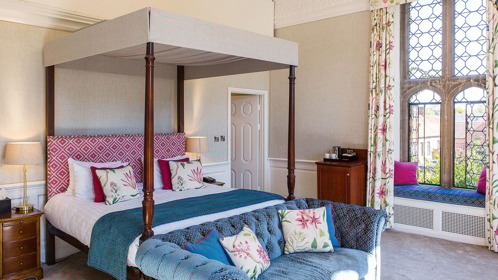 A Historic room in the main house with a four-poster bed and large windows with additional seating areas.