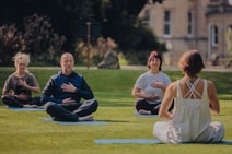 Group of people enjoying a guided meditation in the sun
