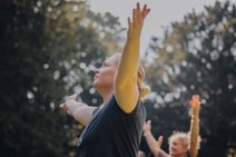 Group of people enjoying a guided meditation in the sun