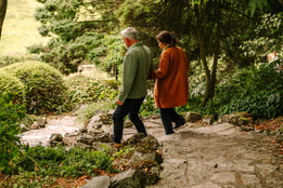 Two guests wandering through the grounds of Cricket St Thomas