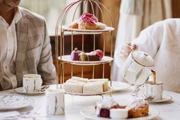 Traditional afternoon tea with a selection of sandwiches and sweet treats.