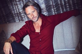 Chesney Hawkes sitting in red jumper