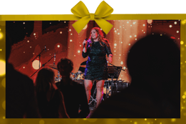 Woman on stage with a bow border