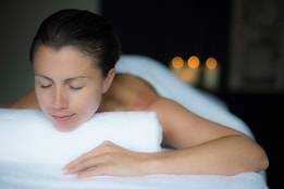 Person looking relaxed as they lay ready for a massage