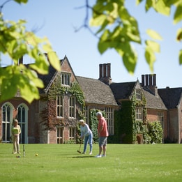 Guests playing croquet on the grounds of Cricket St. Thomas