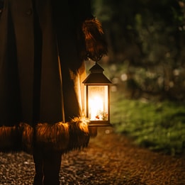 Guests wandering through the grounds on a lantern lit walk