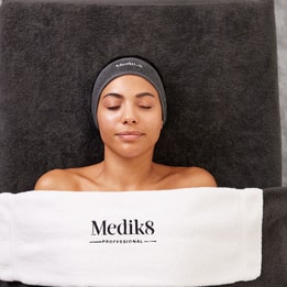 medik8 branded towel on a women getting a massage