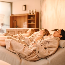 women in spa robes on spa beds