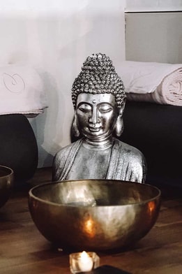 Buddha head surrounded by three sound bowls