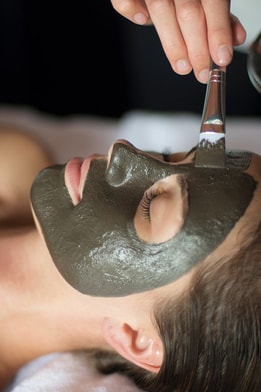 A guest enjoying a facial spa treatment during her spa break