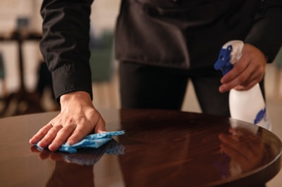Team member cleaning a table
