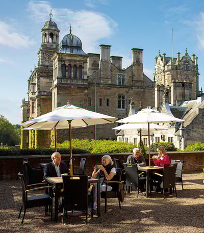 Guests on the terrace at Thoresby Hall having drinks from the Coffee Nest in the summer sun