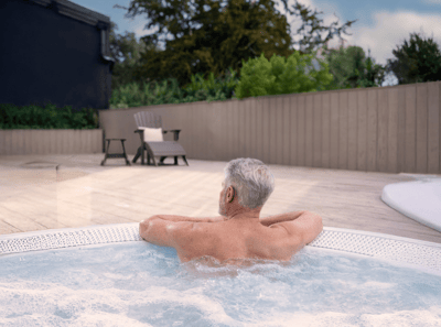 Man enjoying the outdoor heated bubble pool at Heythrop Park