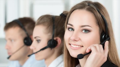 Meet the friendly face of the Warner Hotels contact centre! This image shows a woman wearing a headset, radiating happiness as she assists customers.