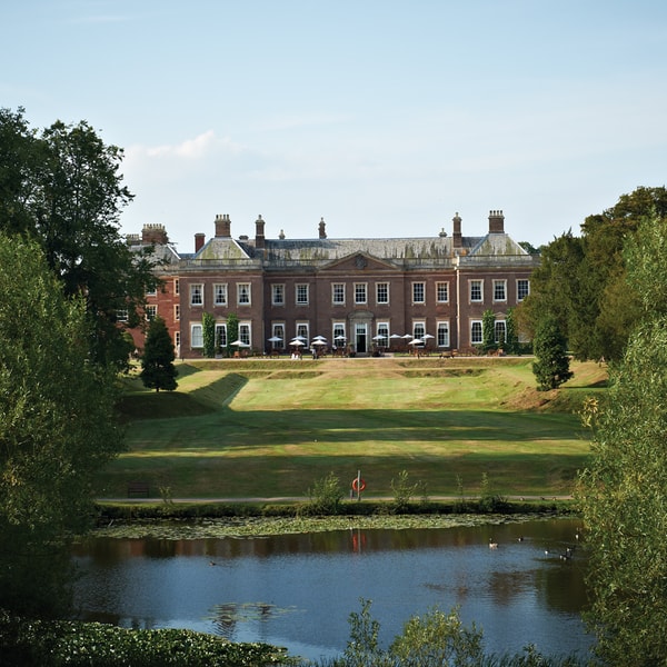 Find this view of the manor house from the opposite side of the vast lake situated in the grounds.