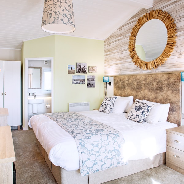 Inside the woodland lodge rooms with a nautical theme featuring a comfortable bed and other modern commodities.