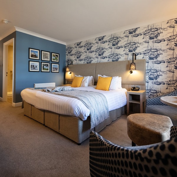 A large room found in the Signature rooms with bed and additional seating.