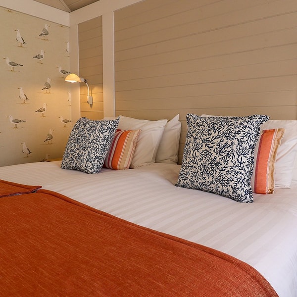 The bedroom inside a Clifftop Lodge at Corton promises soft sheets to sink into for a peaceful night of rest.