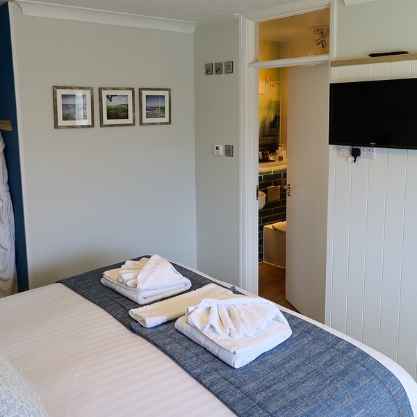 A Premier Chalet with a comfortable bed, en-suite bathroom and wide screen TVs.