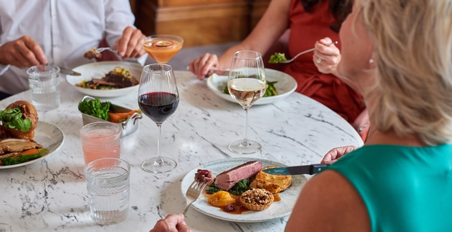 Guests enjoying a meal in the Brasserie32 restaurant at Heythrop Park Hotel