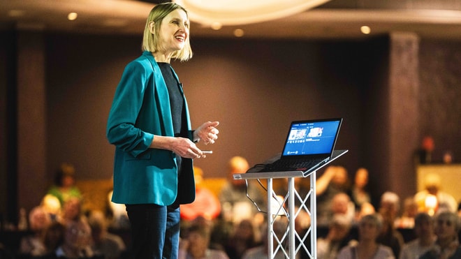 Captivating conference speaker engaging the audience with an insightful presentation at BBC History Magazine Weekends.
