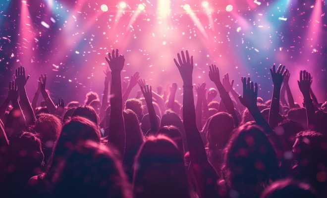 Guests dance with hands in the air