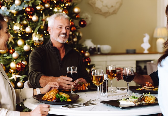 Guests toasting as they celebrate Christmas together at a Warner Hotel
