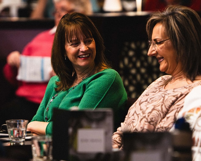Two ladies laughing together