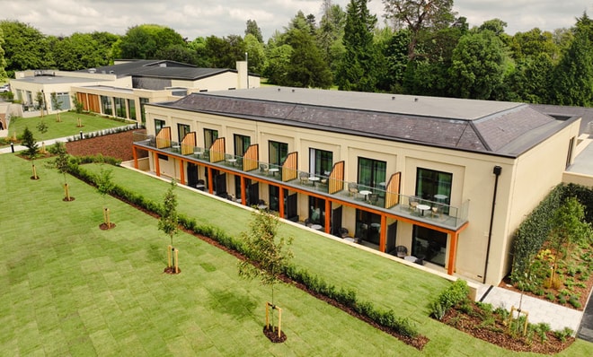 Aerial view of Heythrop Parl hotel new deluxe rooms featuring balcony rooms, manicured lawns, and surrounding lush greenery.