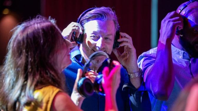 A man enjoying the music and dancing with friends