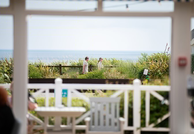 Guests walking along the seafront at Corton