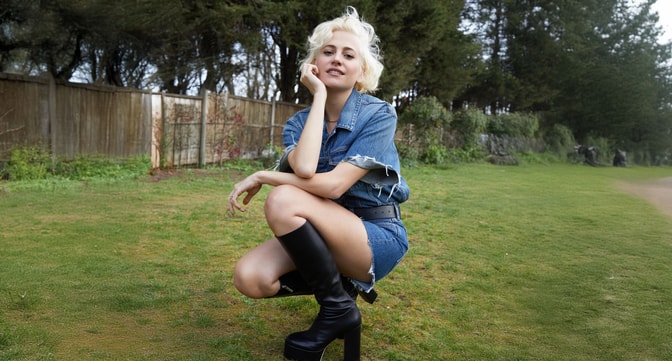 Pixie Lott posing in a field