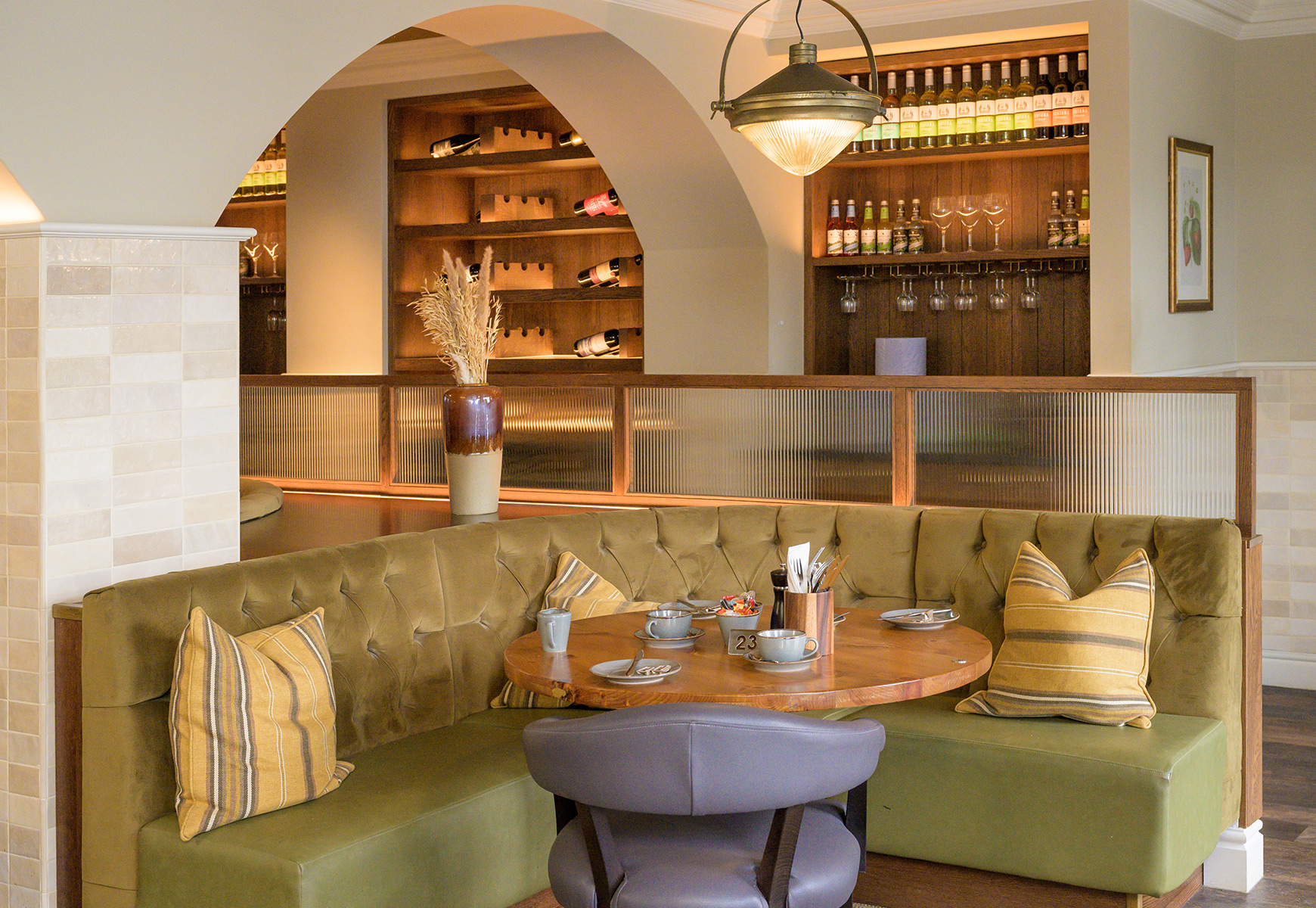 green upholstered booth with a table in a restaurant